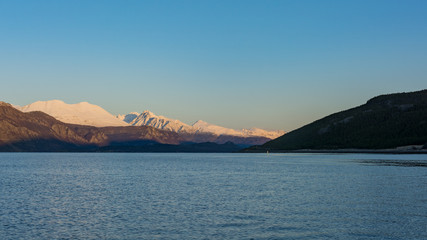 Snow-topped mountains around sunrise in northern Norway