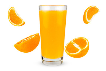Glass of juice with falling oranges on white background
