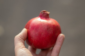 ripe pomegranate lies on the street close-up