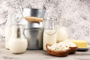 Different  healthy dairy products on rustic background with milk, cheese, butter and cottage