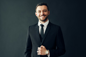 Happy handsome businessman in elegant suit