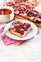 Tasty breakfast. Delicious pie with berries and cottage cheese an a cup of tea
