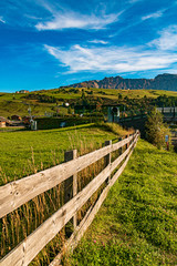 Fototapeta na wymiar Beautiful alpine view with a wooden fence at the famous Seiser Alm, South Tyrol, Italy