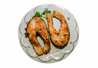 red fish in a plate, top view. Grilled salmon. Steak, in a plate, isolated on a white background.