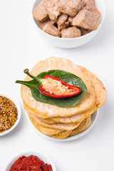 cornmeal tortillas on a white plate nearby. Mexican cuisine.