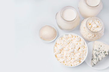 Dairy products cottage cheese, sour cream, milk, blue cheese, mozzarella cheese, sourdough for cheese and cottage cheese. White background. View from above. copy space