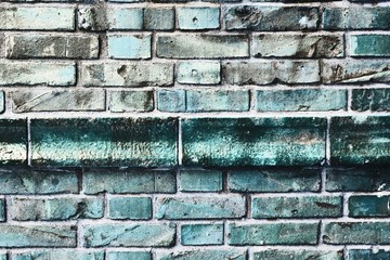 Detailed close up view on blue colored aged and weathered bricks walls in high resolution