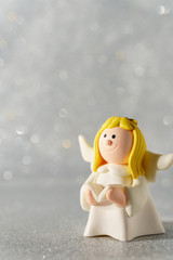 Angel figurine on a beautiful bokeh background with empty space for text.