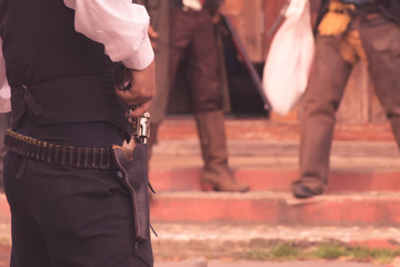 back view of cowboy with gun prepares to gun fight.cowboy with gun.