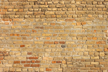 The brick texture of the castle wall. Old orange brick wall background. Close-up. Texture