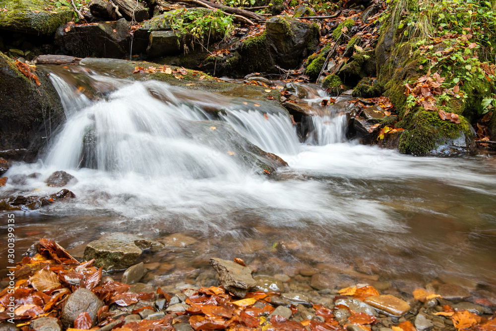 Poster Colorful majestic waterfall in autumn forest