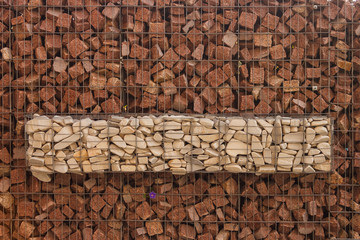 The texture of the gabion fence is made of natural stone and metal mesh
