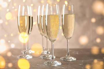 Champagne glasses against blurred lights background. Bokeh effect