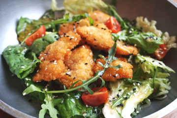 salad with arugula and chicken nuggets with cherry tomatoes