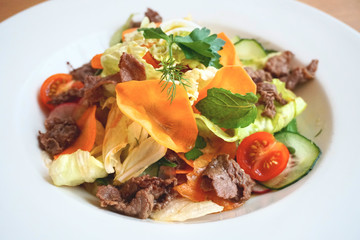 salad of fresh vegetables and greens with veal