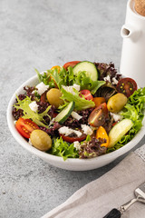 Salad of fresh vegetables and herbs with olives and feta cheese.