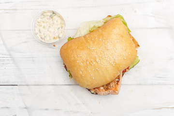 Appetizing sandwiches on a white wooden background. Fast food concept. Top view.