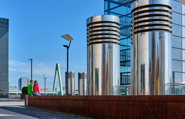 Tourists in Cologne near Kranhaus building complex with crane house on riverside of Rhein in Cologne, Germany.