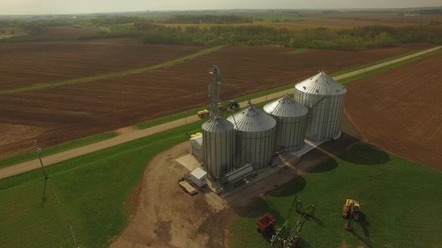 Towing tractor drives down road in Illinois, wide aerial