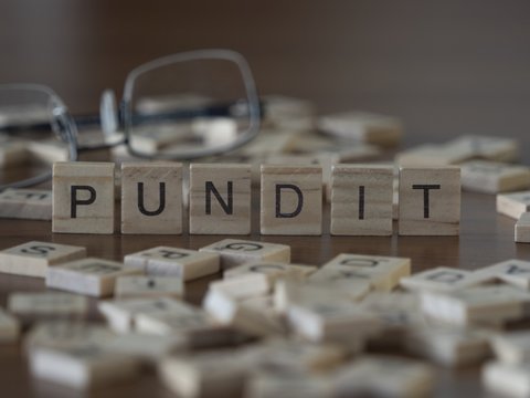 The concept of Pundit represented by wooden letter tiles