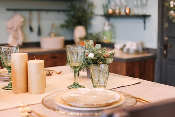 Festive table setting for Christmas dinner at home. New year and Christmas decorations. Winter holiday theme. Happy New Year 2020