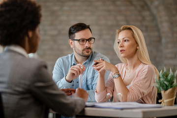 Couple having consultations with insurance agent in the office.