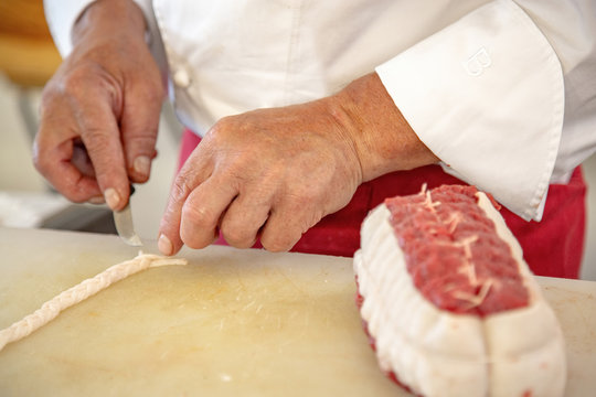 butcher preparing a rosbeef on his work plan