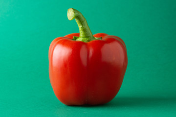 Red ripe peppers on a green background