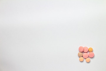 Colored pills on white background. Concept of medication abuse.