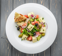 Greek salad with hard cheese and olives