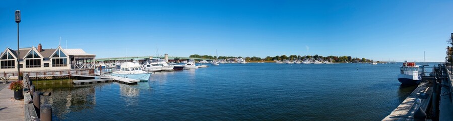 Fototapeta na wymiar Yachts at pier on Merrimack River panorama in downtown Newburyport, Massachusetts, MA, USA.