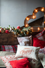 Cozy bed with Christmas pillows decorated with Christmas decor