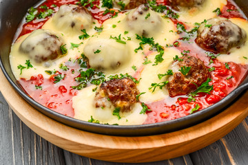 beef meatballs with tomato sauce and parmesan cheese in pan