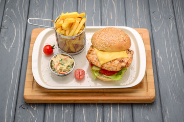 Tasty and appetizing hamburger cheeseburger. On a wooden table