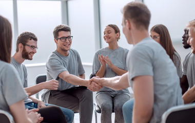 handshake of young people in a circle of like-minded people.