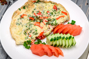 Turkish breakfast: omelet with vegetables in a pan close-up.