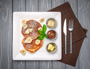 Stack of Turkish -style pancakes with a banana and chocolate
