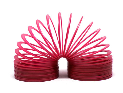 BANGKOK, THAILAND - MARCH  20, 2018 : RED slinky spring toy Isolated on white background. Illustrative editorial.
