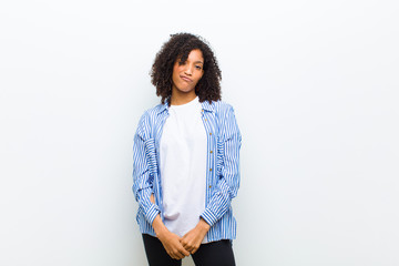 young cool african american woman looking happy and friendly, smiling and winking an eye at you...