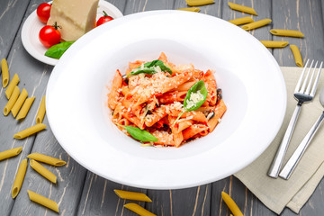 Penne pasta with shrimp and mussels, tomato sauce, basil and grated parmesan cheese