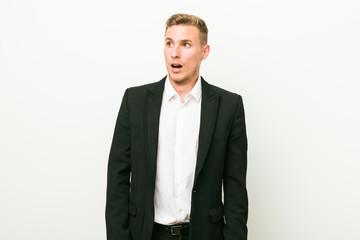 Young caucasian business man being shocked because of something she has seen.