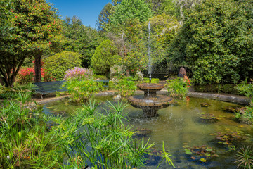 Fototapeta na wymiar Beautiful Water Fountain Surrounded By Garden And Greenery, Brejoeira Palace, Moncão, Portugal