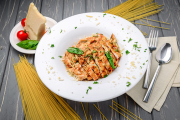 Grilled meat with pasta, cheese, basil and tomato sauce