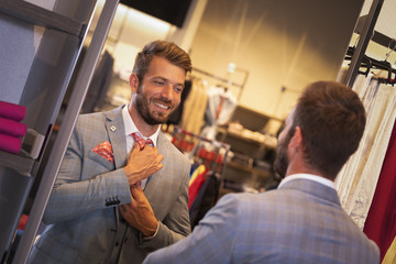 Businessman getting dressed in front of the mirror