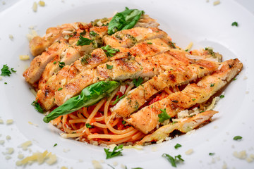 Grilled meat with pasta, cheese, basil and tomato sauce