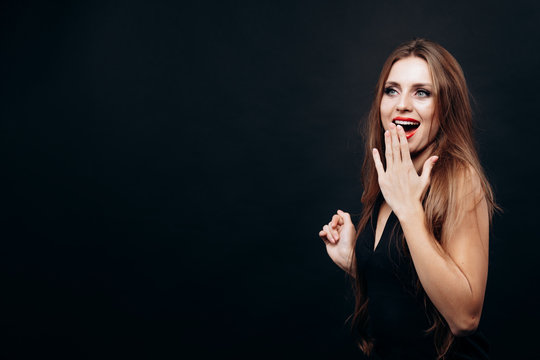 Charming Surprised Young Woman Posing Covering Her Mouth With Hand