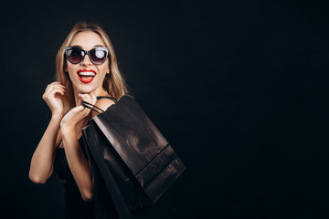Laughing Blonde Demonstrating Paper Bag of Trendy Purchases
