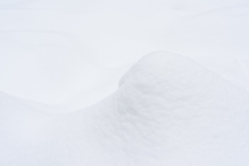 Fragment of an elegant snow dune. Christmas background.