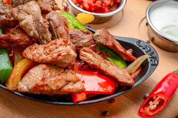 Fried meat with different vegetables with sauce