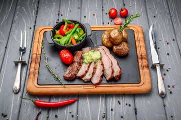 Juicy steak medium rare beef with spices and grilled vegetables